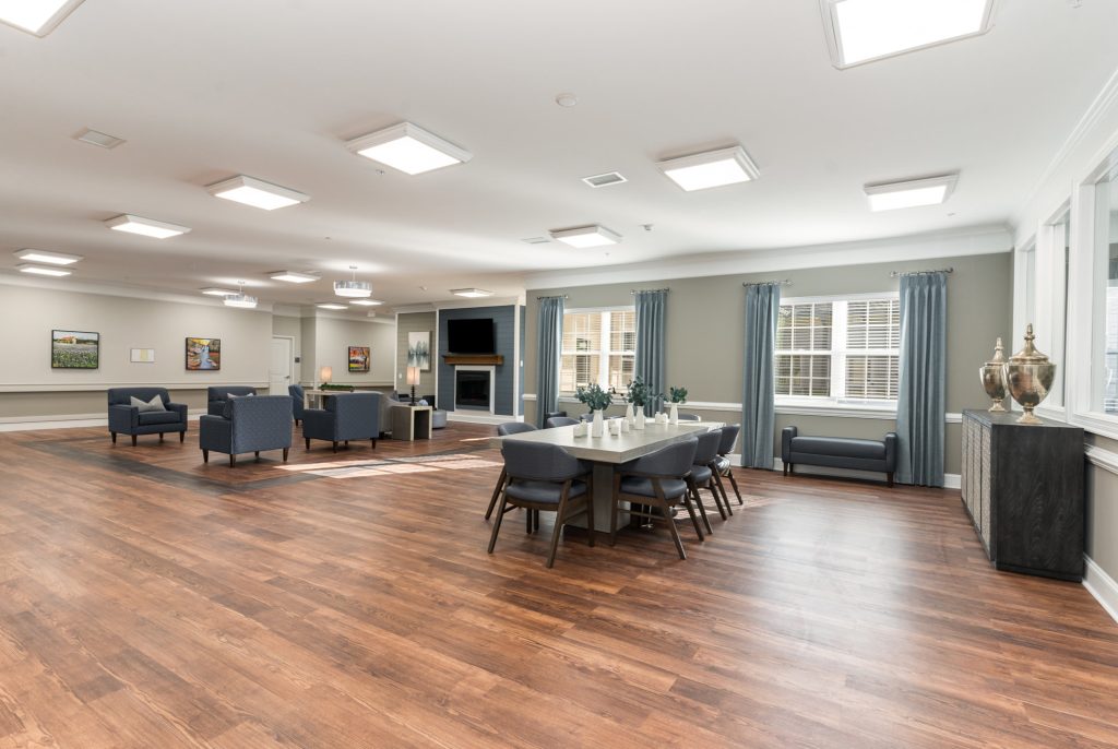 Expansive social hall with ample seating, bright lighting, and stylish decor. Ideal for community events and gatherings.