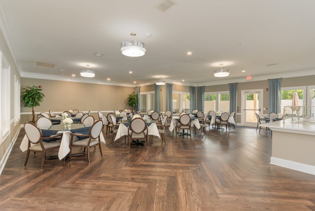Contemporary dining room with multiple seating arrangements, featuring modern decor and ample natural light. Perfect for hosting large groups.