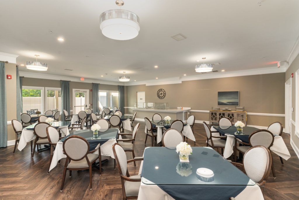 Spacious dining hall with ample seating, perfect for large gatherings and community events. Features stylish lighting and modern decor.