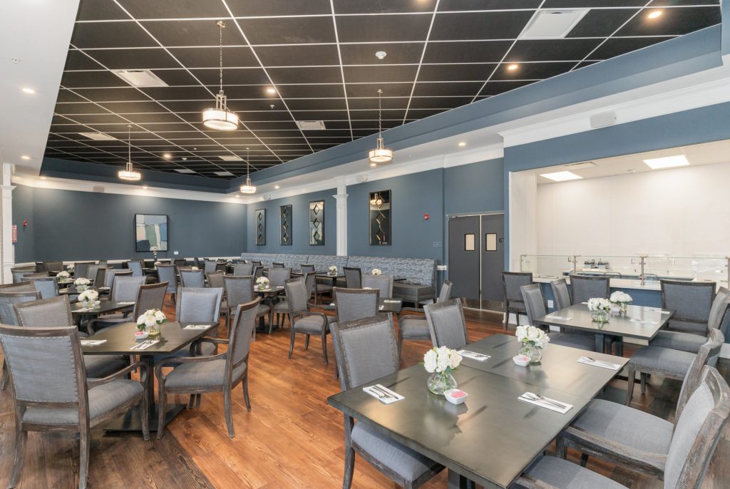 Spacious dining hall featuring stylish decor, modern lighting, and ample seating. Ideal for communal dining and special events.