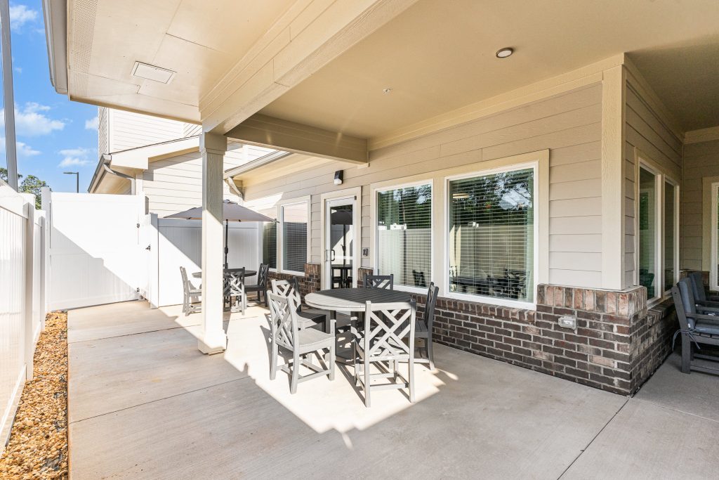 Charming outdoor patio area with tables and umbrellas, perfect for relaxing and enjoying the fresh air. Ideal for social gatherings and outdoor meals.