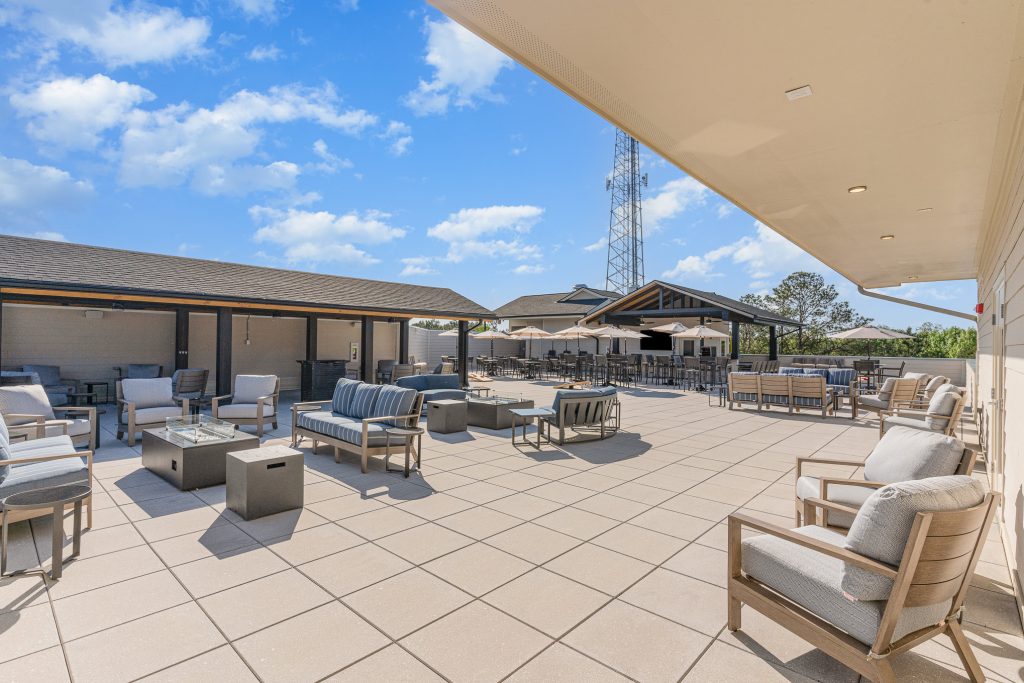 Expansive rooftop lounge featuring comfortable seating, fire pits, and scenic views. Perfect for socializing and enjoying outdoor activities.